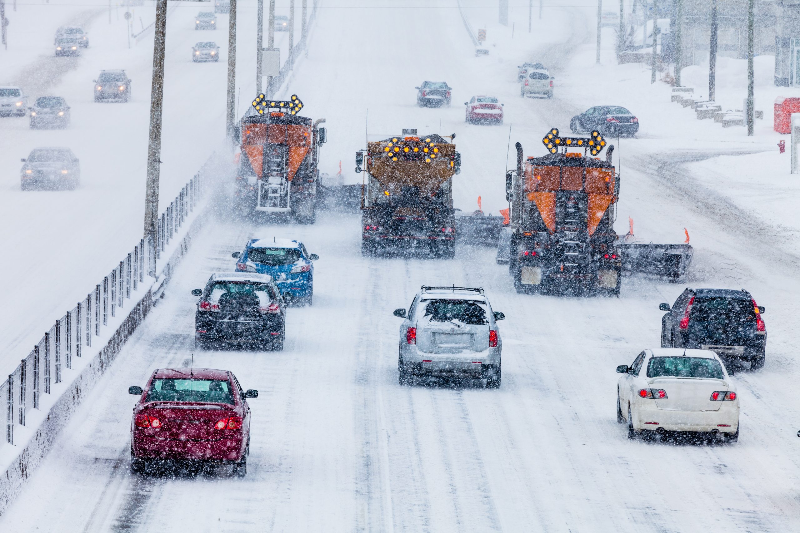 Snowplows plowing municipal highway